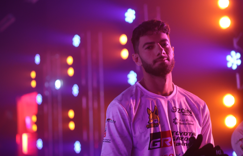 Photo of participant standing in front of stage lights